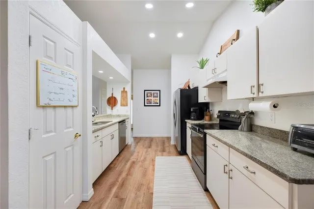 a large kitchen with stainless steel appliances lots of counter space