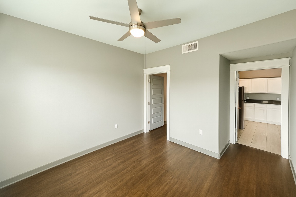 200 Maple Lane, Unit 1201 Elgin, TX 78621 - Photo 10 of 23 an empty room with wooden floor closet and windows