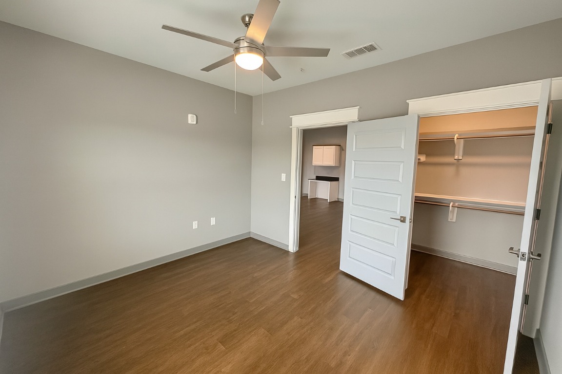 200 Maple Lane, Unit 1201 Elgin, TX 78621 - Photo 11 of 23 an empty room with wooden floor ceiling fan