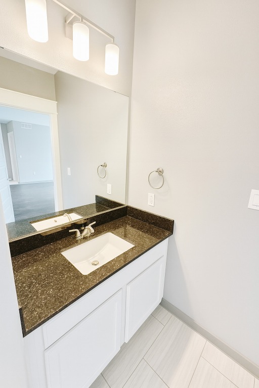 200 Maple Lane, Unit 1201 Elgin, TX 78621 - Photo 13 of 23 a bathroom with a granite countertop sink and a mirror