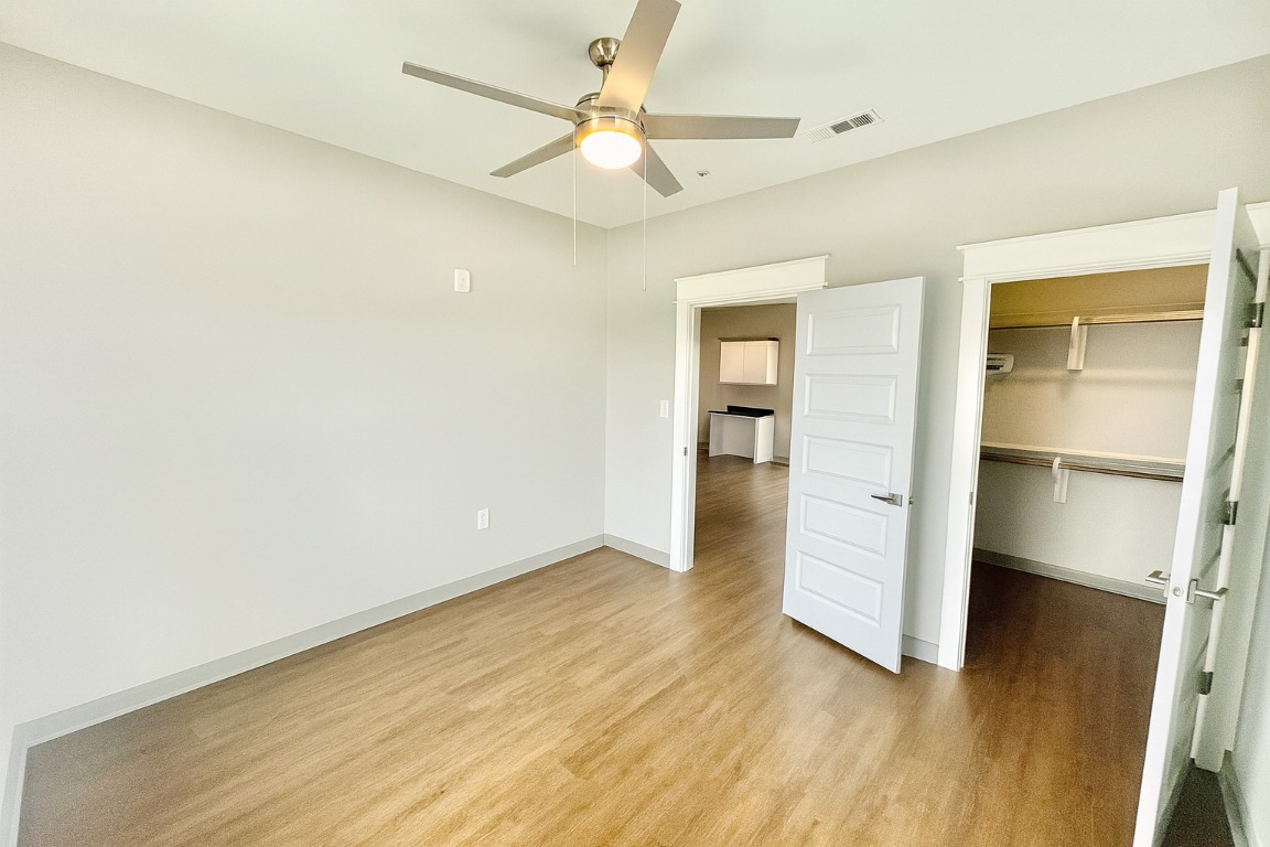 200 Maple Lane, Unit 1201 Elgin, TX 78621 - Photo 15 of 23 wooden floor in an empty room