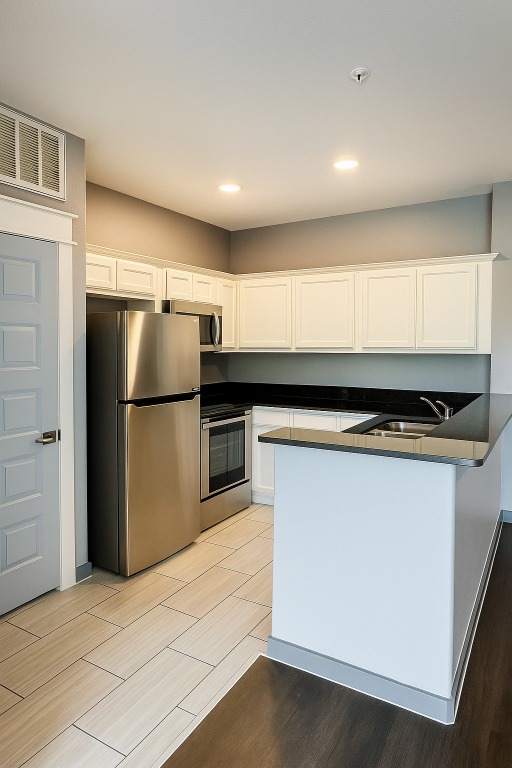 200 Maple Lane, Unit 1201 Elgin, TX 78621 - Photo 7 of 23 a kitchen with a refrigerator and a stove