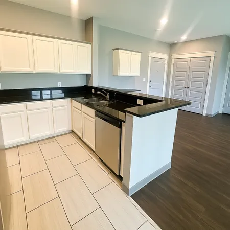 a kitchen with a refrigerator and a stove