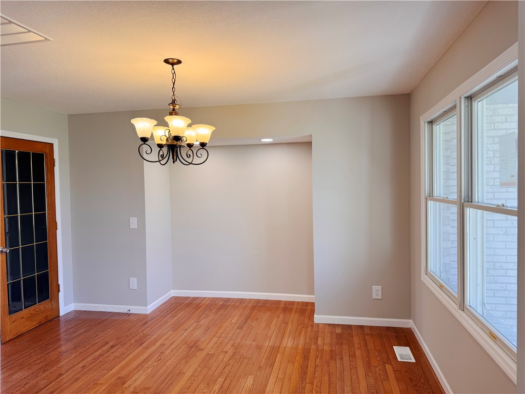 1118 Wedgewood Court Decatur, IL 62526 - Photo 6 of 22 a view of an empty room with wooden floor and a window
