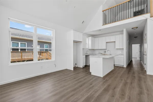 a view of open kitchen with wooden floor and electronic appliances