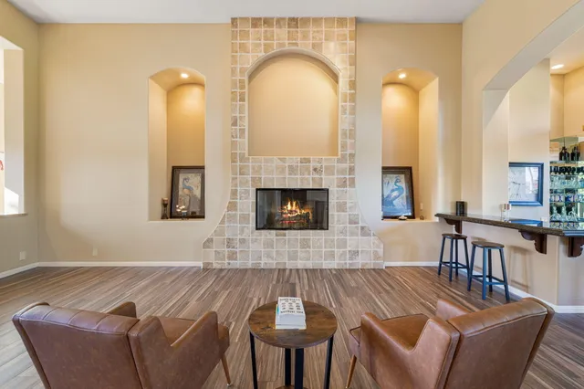a living room with fireplace furniture and a fireplace