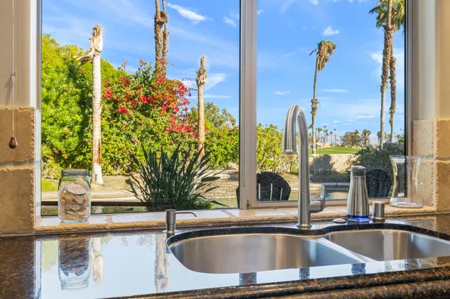 a bedroom with double bed and a large window