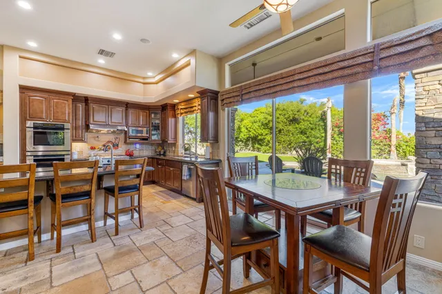 a view of a house with a yard and potted plants