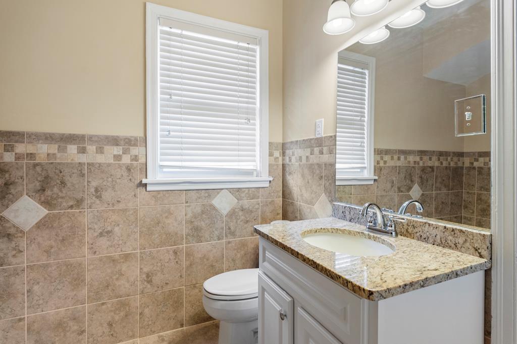 1500 Preston Drive Columbus, GA 31906 - Photo 20 of 29 a bathroom with a granite countertop sink and a mirror