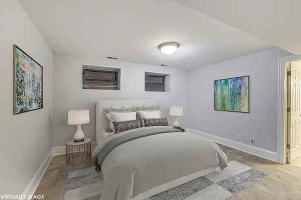 a bedroom with a bed and a painting on the wall