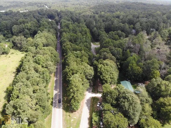 an aerial view of a houses with yard