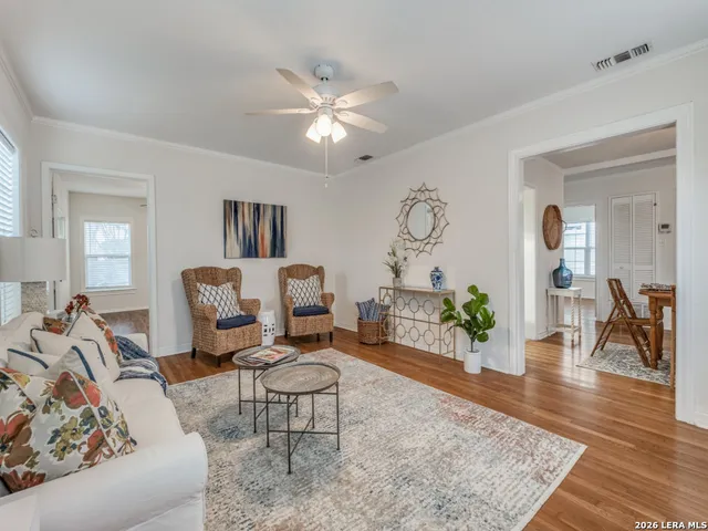 a living room with furniture and wooden floor