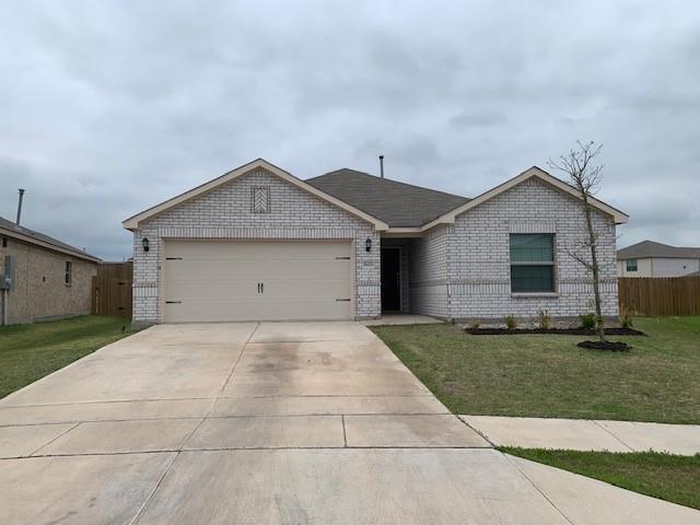 Single story home featuring a front yard and a garage