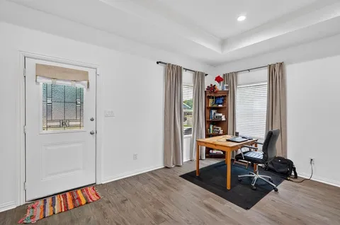 a view of a workspace with furniture and empty room