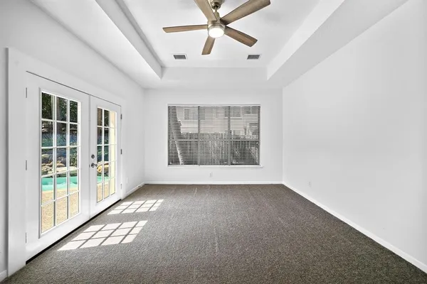 an empty room with windows and entrance