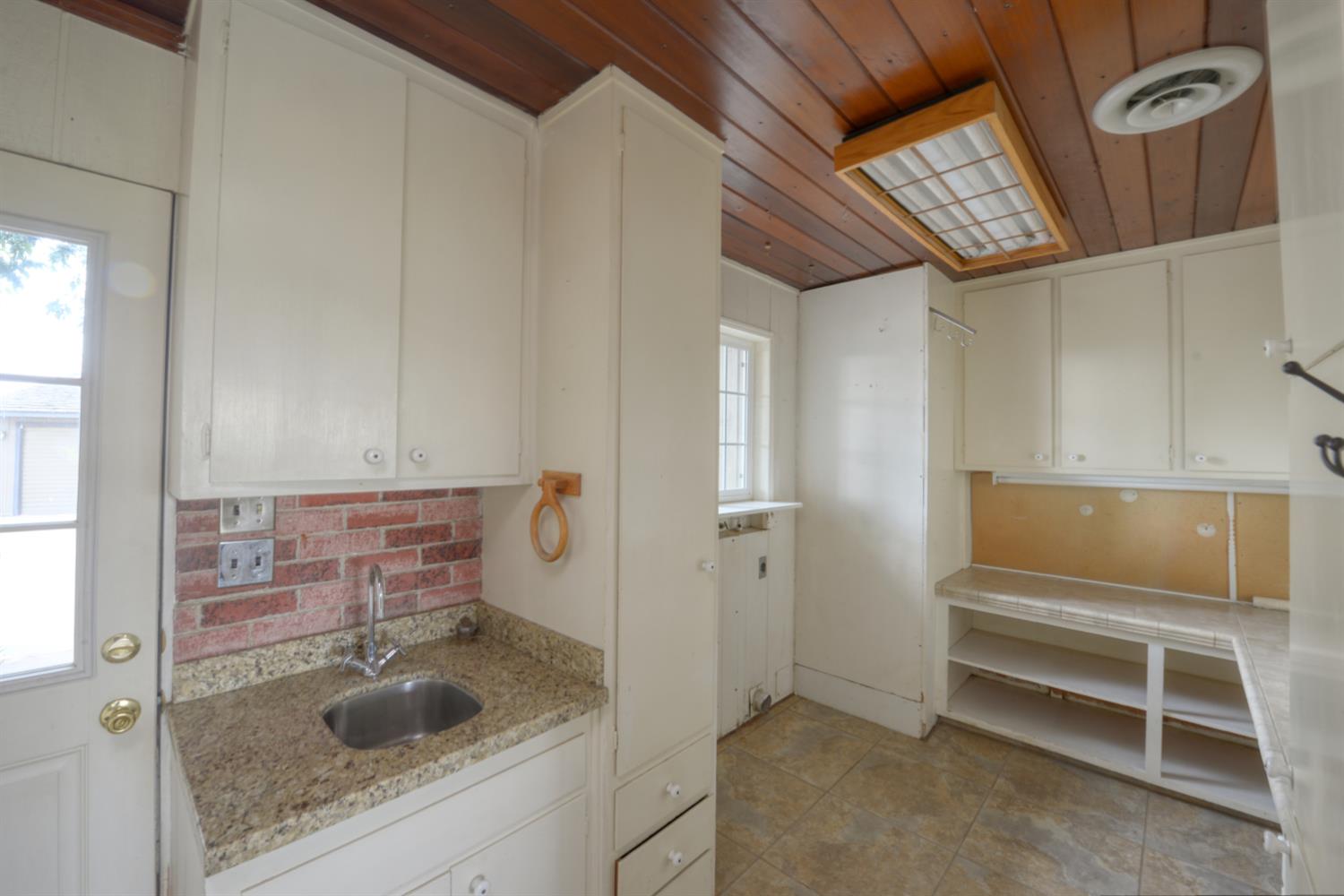 2931 East Marshall Road Patterson, CA 95363 - Photo 13 of 54 Large Laundry room off back door with sink, cabinets and drawers