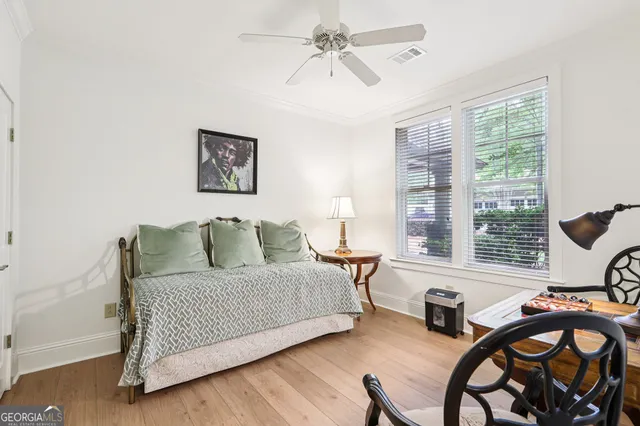 a bedroom with a bed and a table chair