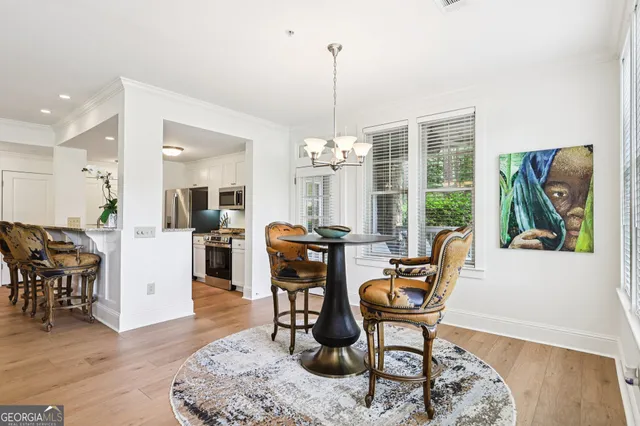 a living room with furniture a chandelier and a fireplace