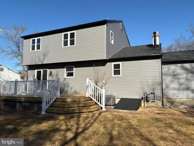 a view of a house with wooden fence