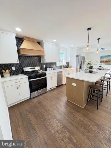 a kitchen with cabinets a sink and appliances