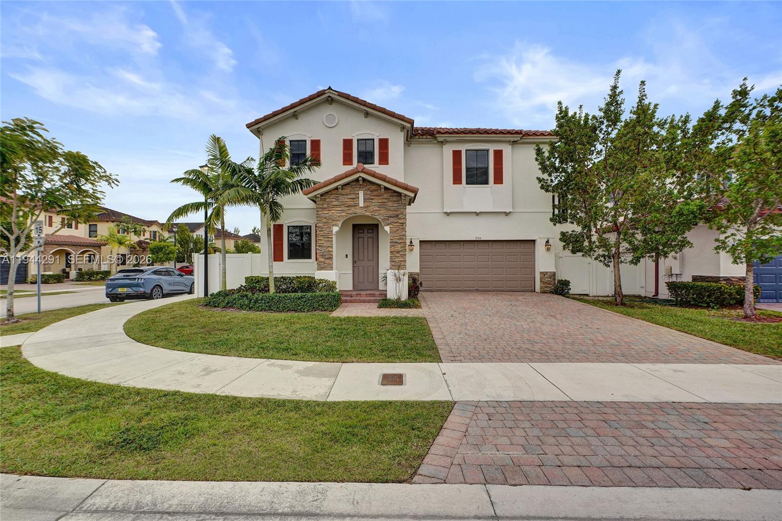 a front view of a house with a yard and garage