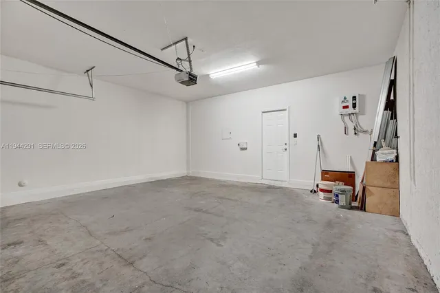 a view of a room with wooden floor and white walls