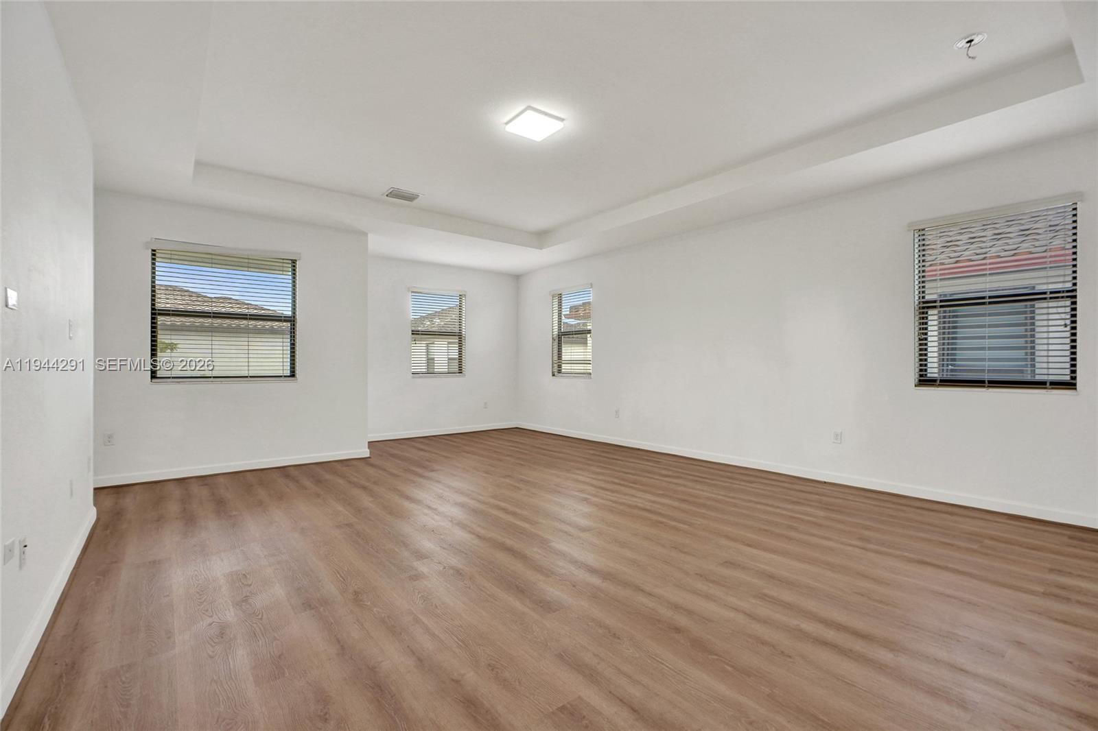 3504 West 94th Street Hialeah, FL 33018 - Photo 30 of 61 a view of empty room with wooden floor and fan