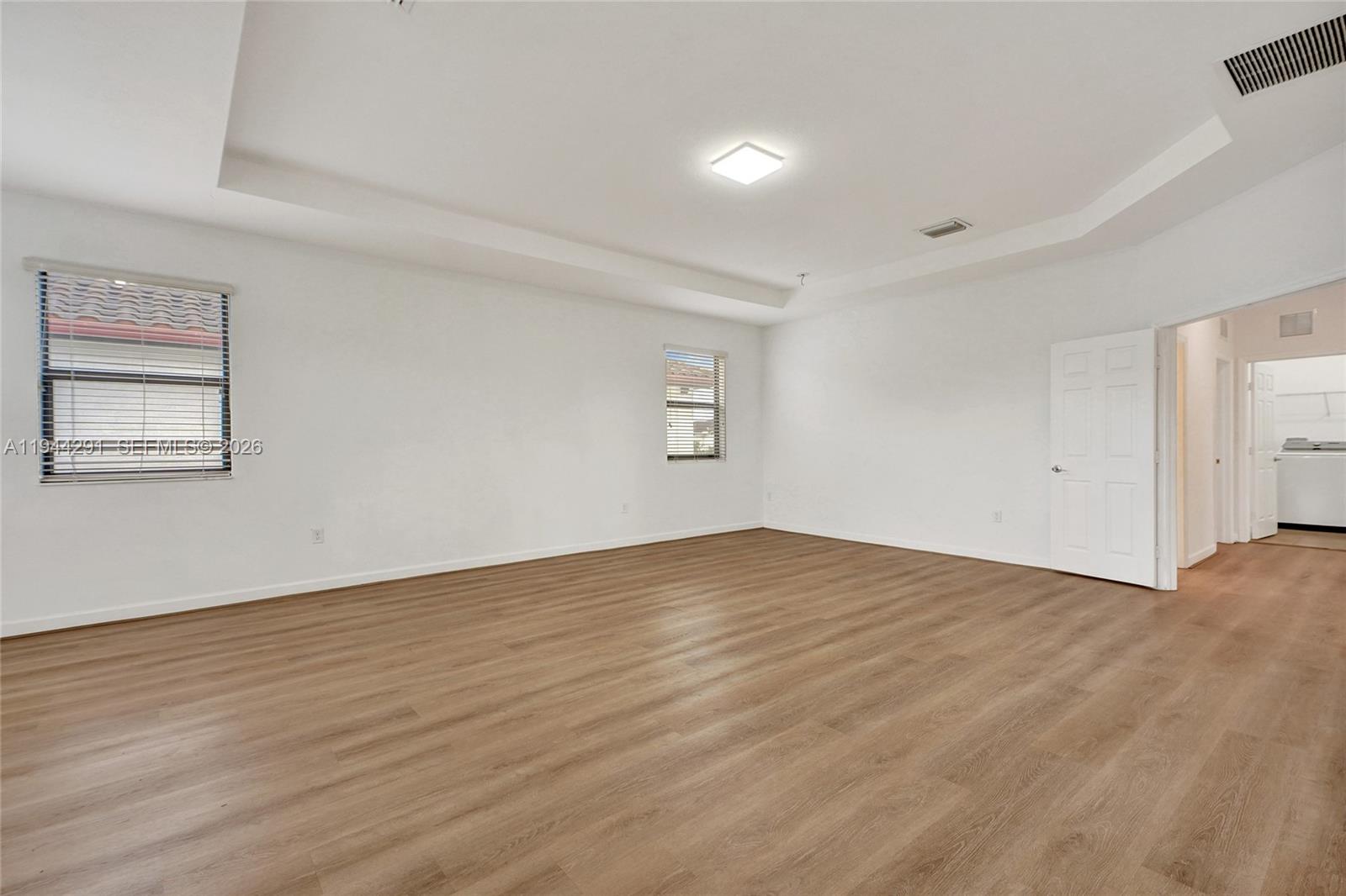3504 West 94th Street Hialeah, FL 33018 - Photo 33 of 61 a view of an empty room with wooden floor and a window