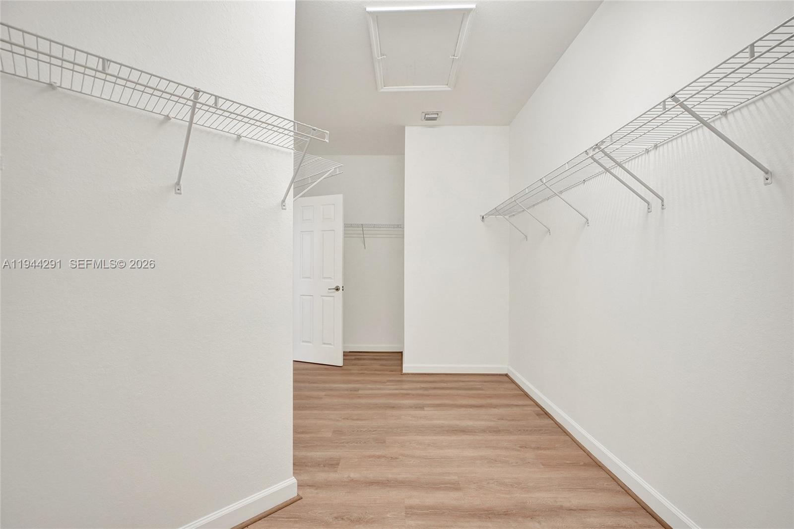 3504 West 94th Street Hialeah, FL 33018 - Photo 36 of 61 a view of a room with wooden floor and white walls