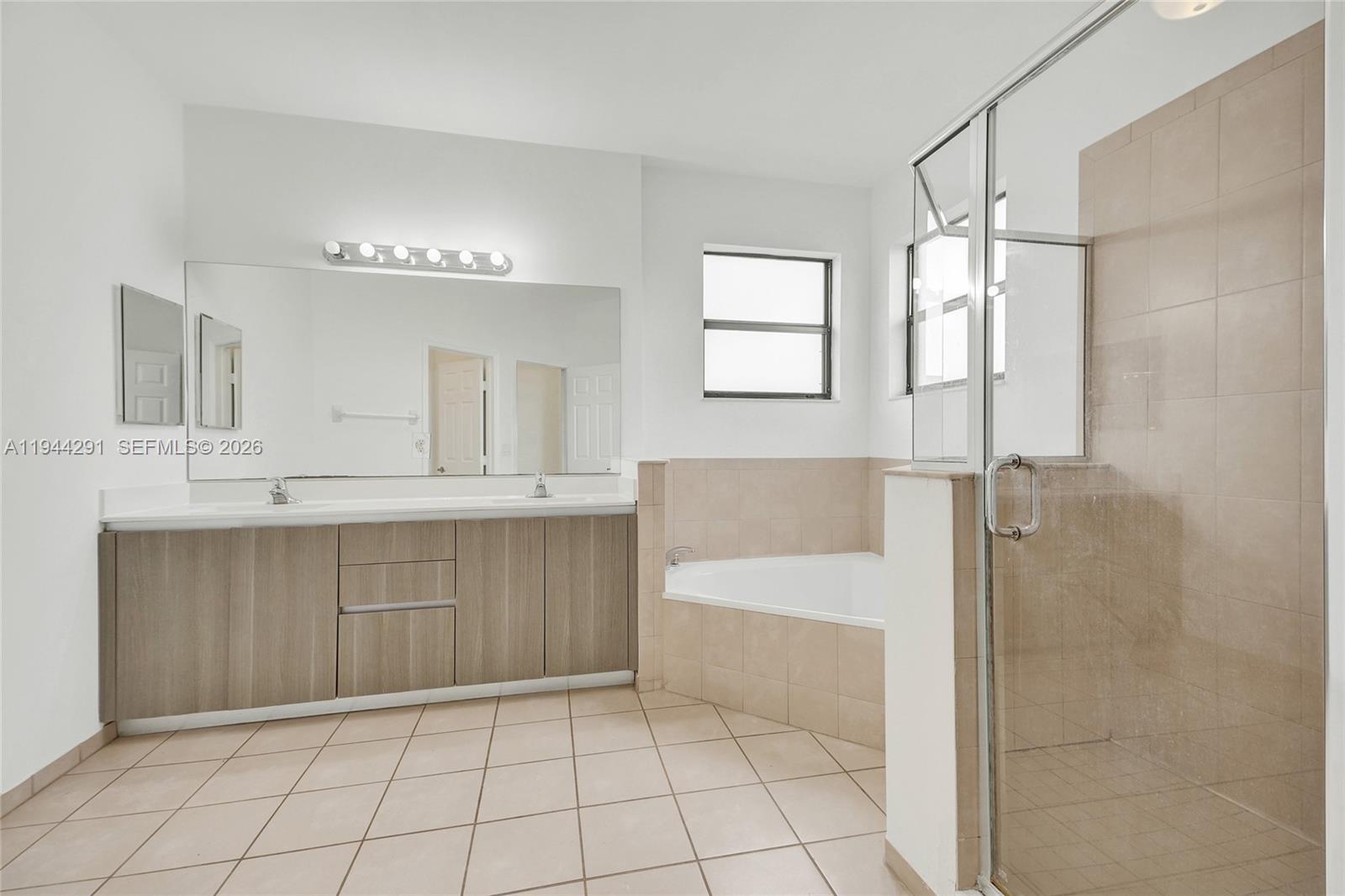 3504 West 94th Street Hialeah, FL 33018 - Photo 37 of 61 a bathroom with a bathtub shower sink and mirror