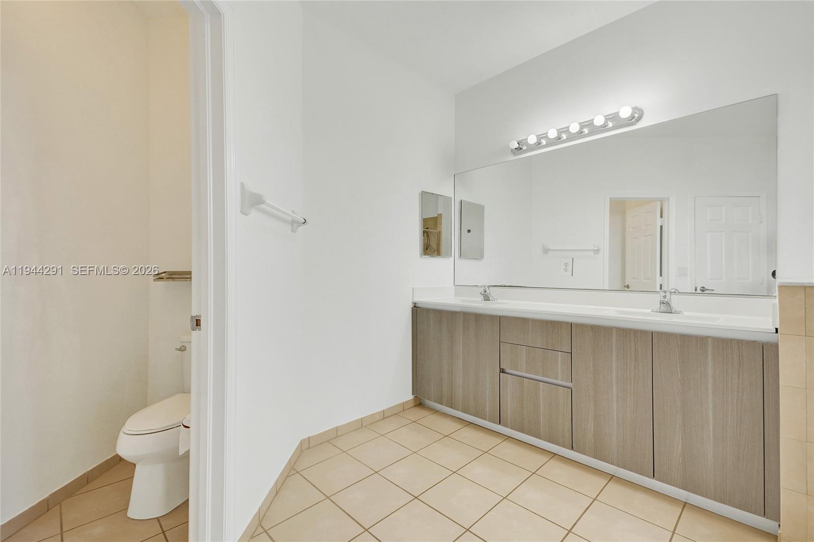 3504 West 94th Street Hialeah, FL 33018 - Photo 38 of 61 a spacious bathroom with a double vanity sink a toilet and a mirror