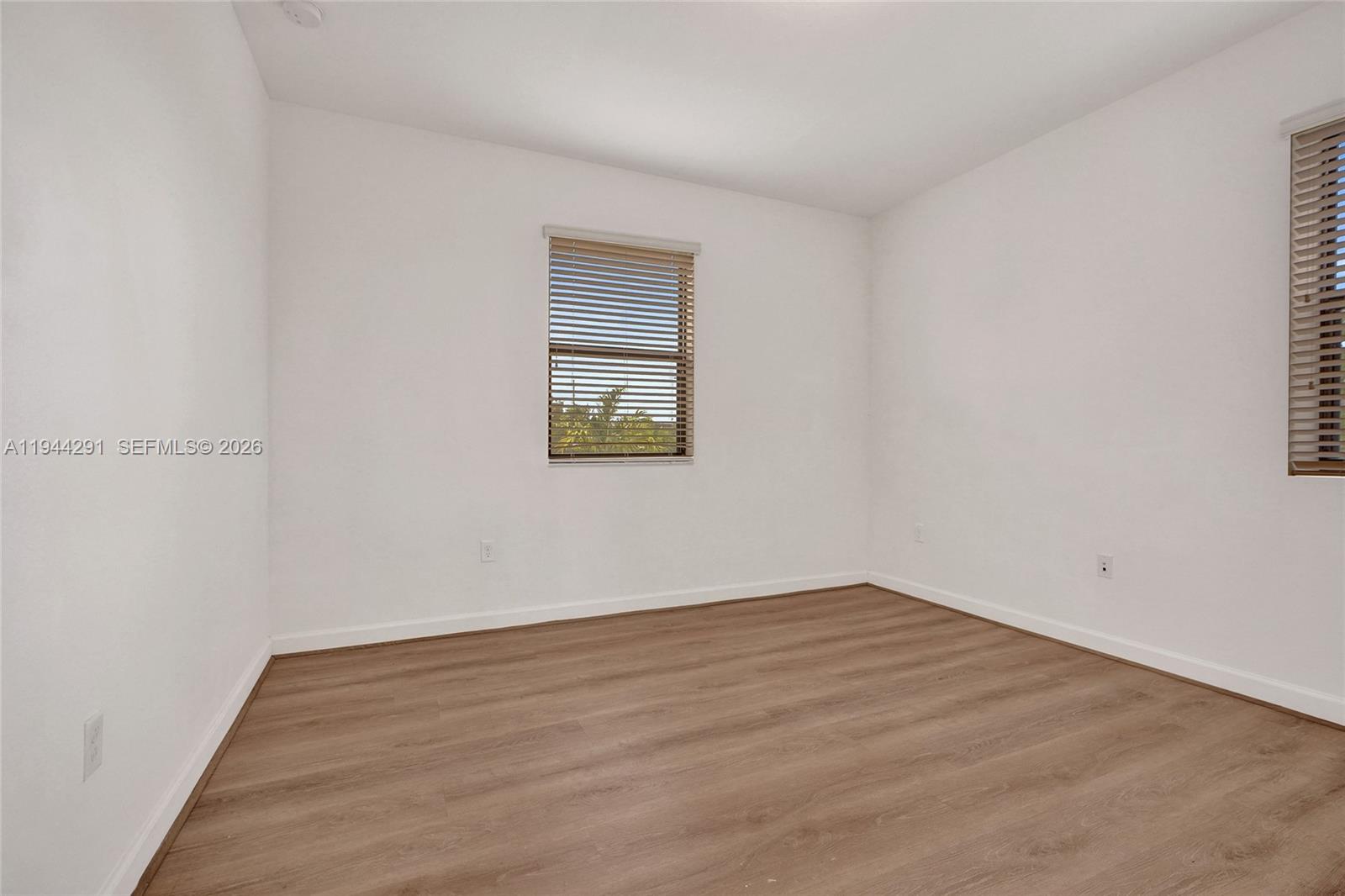 3504 West 94th Street Hialeah, FL 33018 - Photo 42 of 61 a view of an empty room with wooden floor and a window