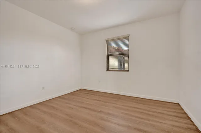 an empty room with wooden floor
