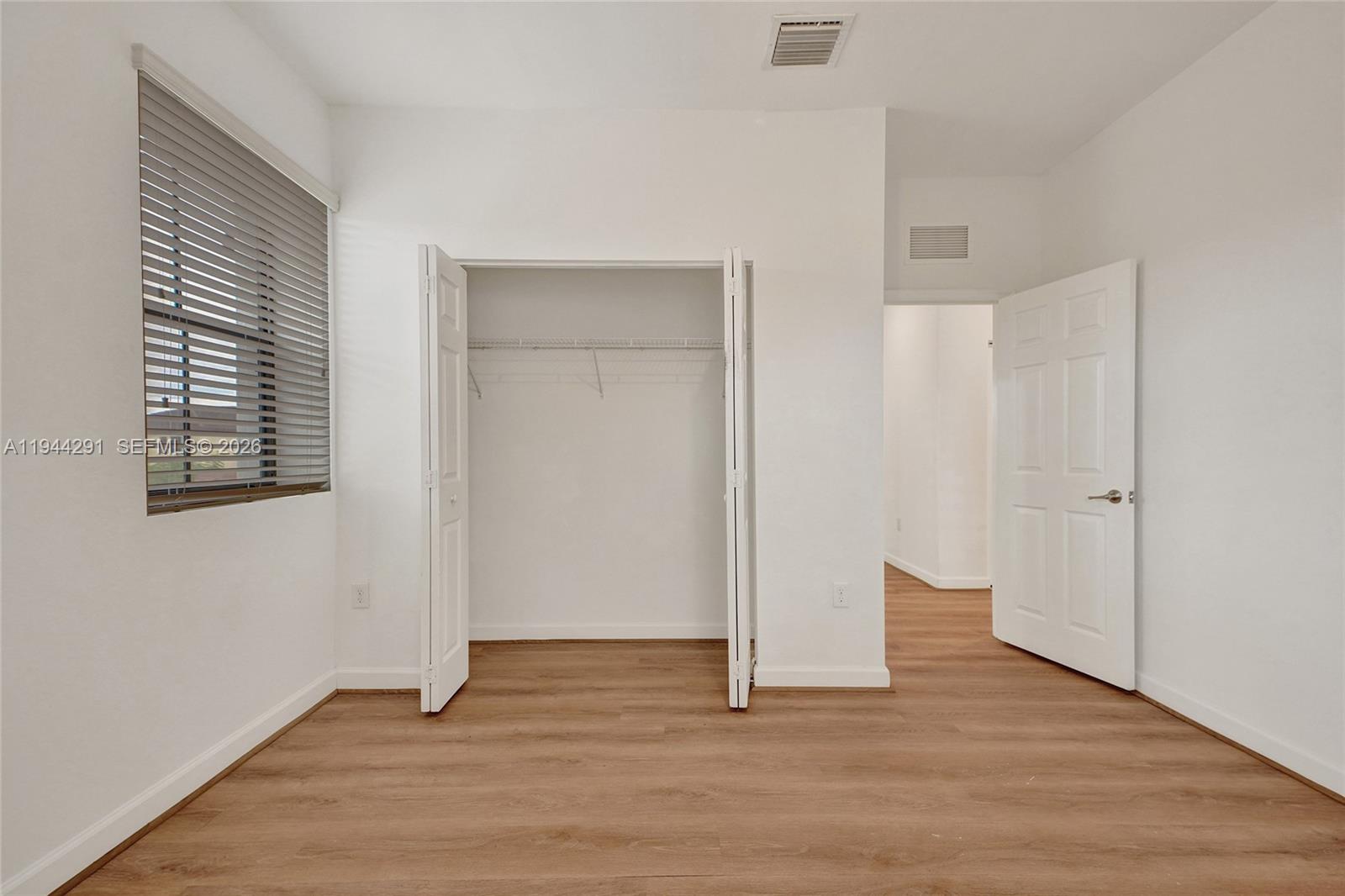 3504 West 94th Street Hialeah, FL 33018 - Photo 46 of 61 a view of an empty room with wooden floor and closet