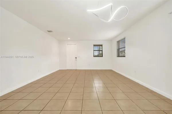 a view of an empty room with stairs