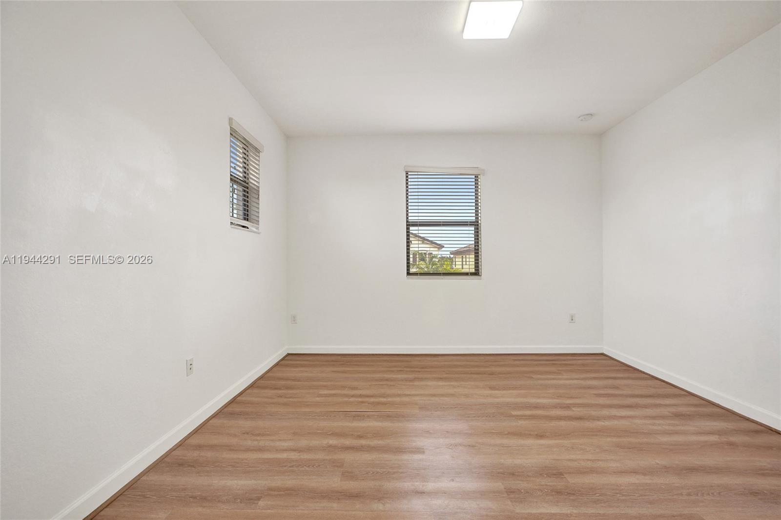 3504 West 94th Street Hialeah, FL 33018 - Photo 52 of 61 a view of an empty room with wooden floor and a window