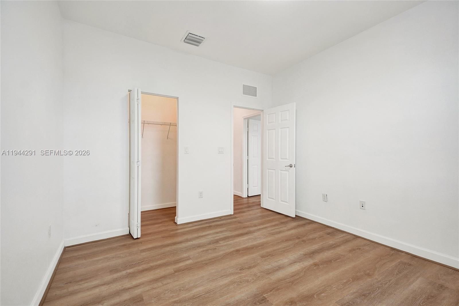 3504 West 94th Street Hialeah, FL 33018 - Photo 55 of 61 an empty room with wooden floor
