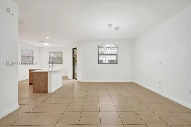 a kitchen with stainless steel appliances a sink and a refrigerator