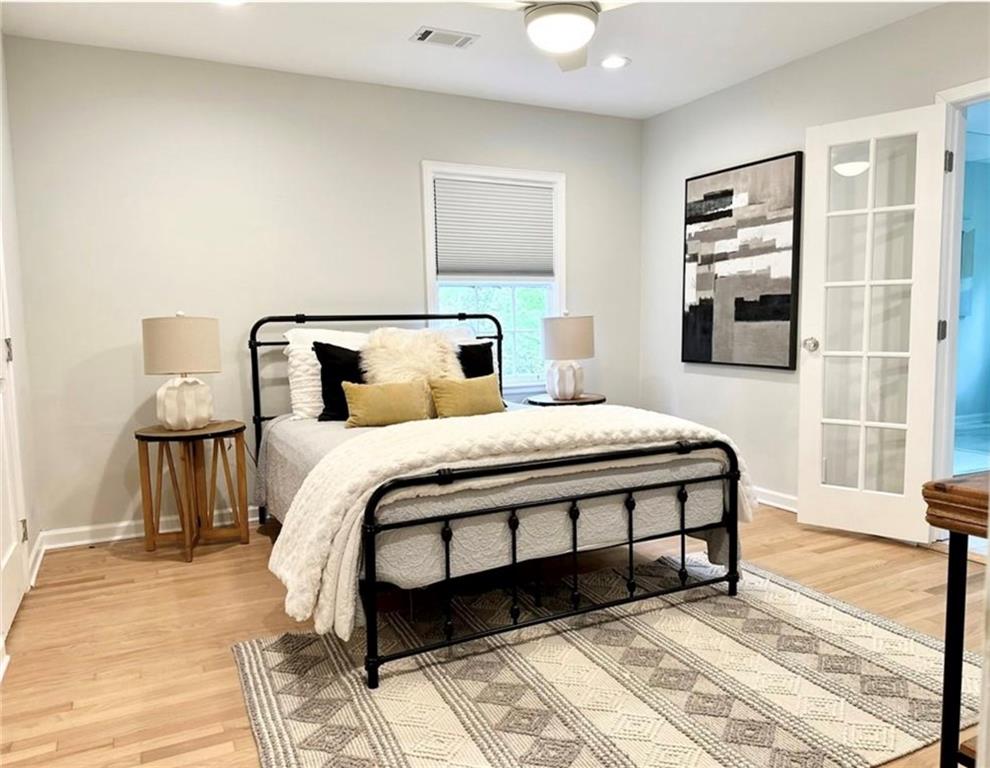 2222 Beecher Road Southwest Atlanta, GA 30311 - Photo 11 of 15 a bedroom with a bed lamp and a large window