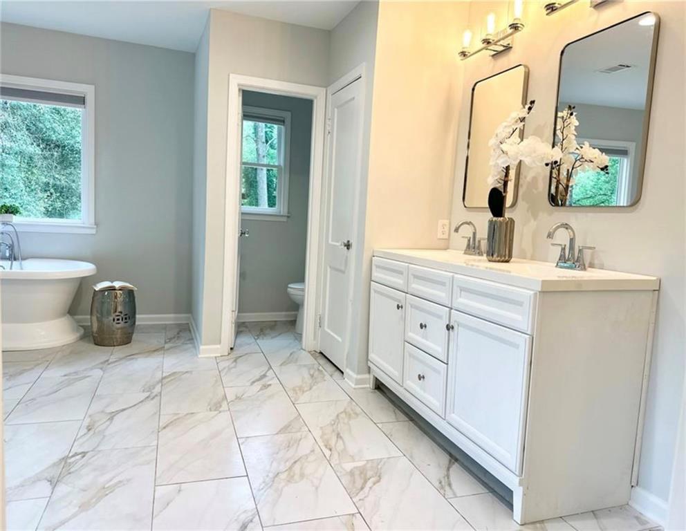 2222 Beecher Road Southwest Atlanta, GA 30311 - Photo 14 of 15 a spacious bathroom with a double vanity sink and a mirror