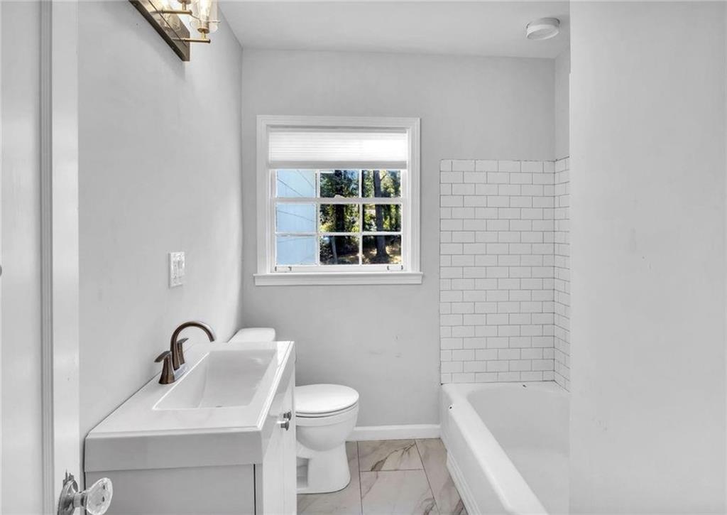 2222 Beecher Road Southwest Atlanta, GA 30311 - Photo 9 of 15 a bathroom with a sink mirror bathtub and toilet