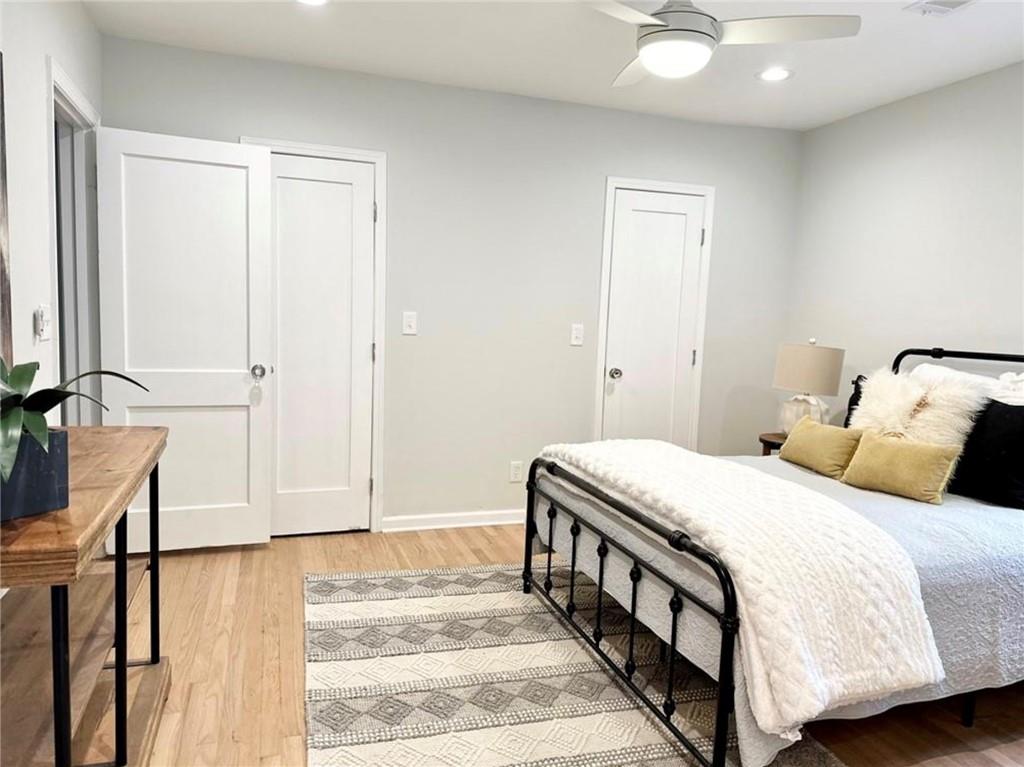 2222 Beecher Road Southwest Atlanta, GA 30311 - Photo 10 of 15 a bedroom with a large bed and a chandelier