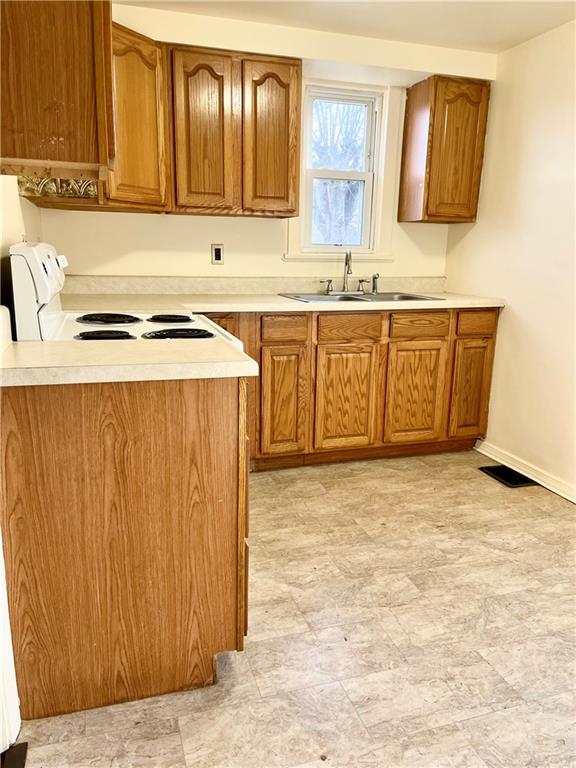 216 Bettis Road Dravosburg, PA 15034 - Photo 3 of 10 a kitchen with stainless steel appliances granite countertop a sink stove and cabinets