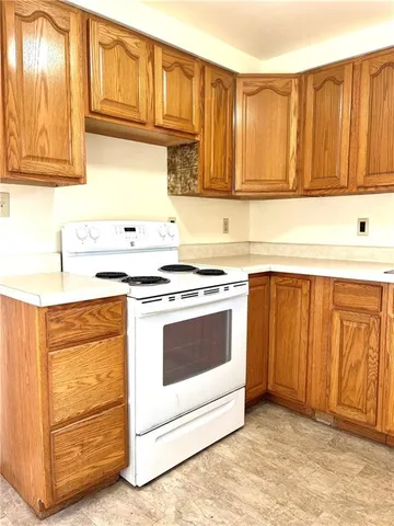 a kitchen with granite countertop cabinets stainless steel appliances and sink