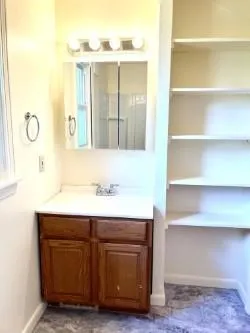a bathroom with a sink vanity granite and a mirror