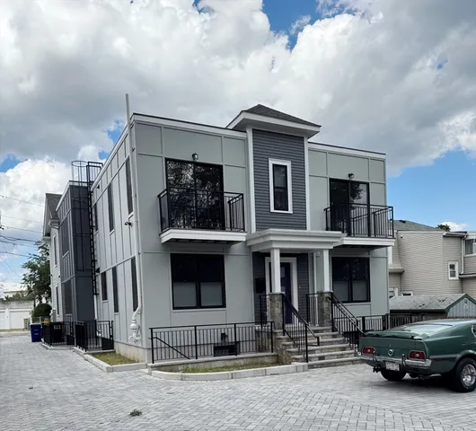 a front view of a house with parking space