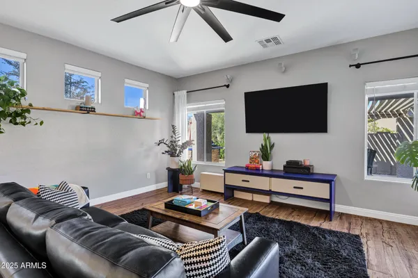 a living room with furniture and wooden floor