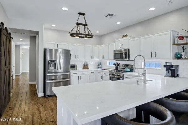a kitchen with a sink stove and cabinets
