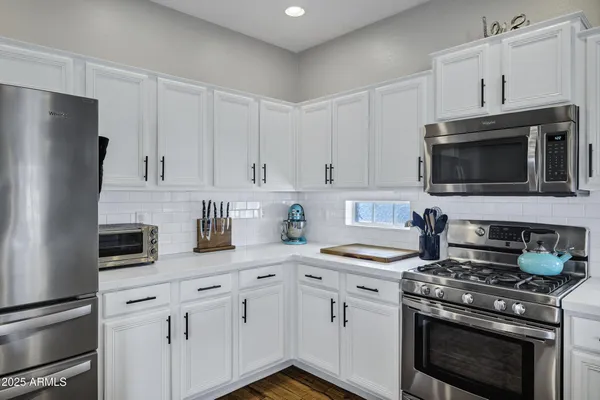 a kitchen with a sink stove and cabinets