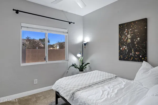 a bedroom with a bed and a potted plant